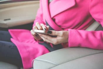 nicely-dressed-woman-using-her-phone-in-a-car-picjumbo-com